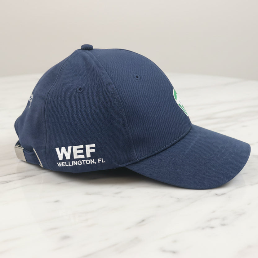 navy hat with white text on a marble table
