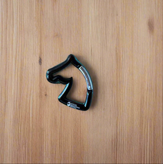 Black carabiner on a wooden surface