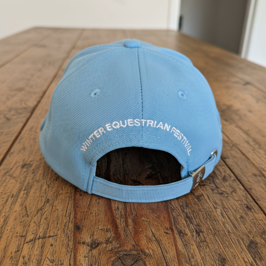 back view of baby blue kids wef hat on wooden table