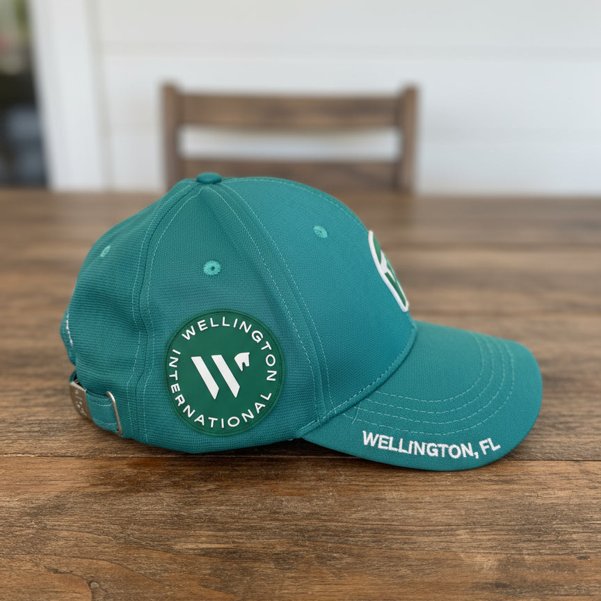 teal wef hat side view on a wooden table